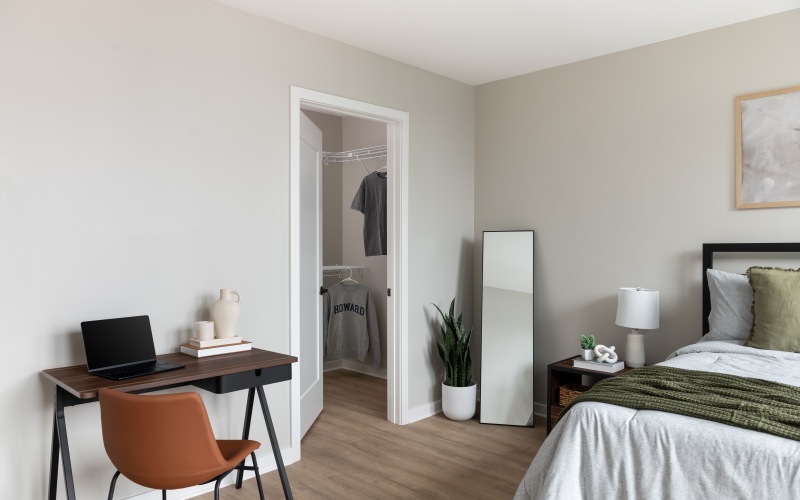 a room with a bed and a desk