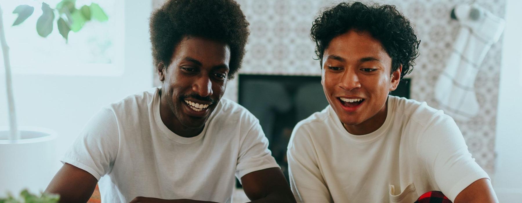 father and son sit together in living room