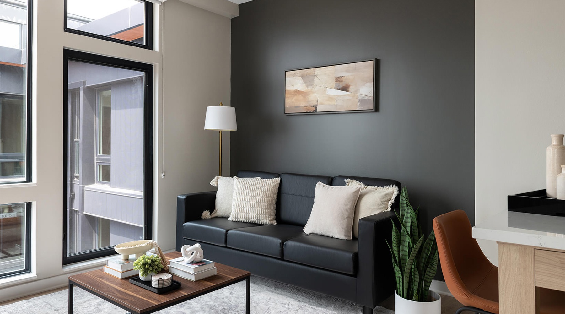 Room with black couch and natural light