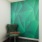 room with table and chair and green wallpaper