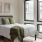 a bedroom with large windows