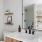 lights over bathroom counter with sink and mirror