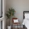 potted plant and chair beside bed