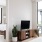 living room tv on console next to large windows